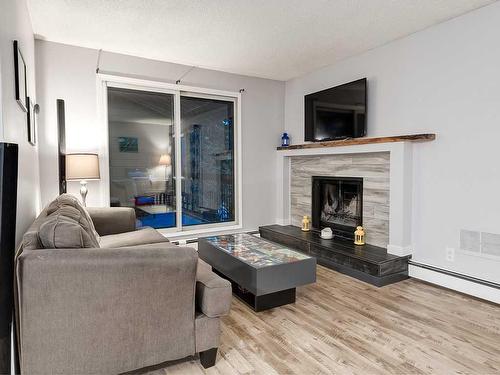 302-2611 15A Street Sw, Calgary, AB - Indoor Photo Showing Living Room With Fireplace