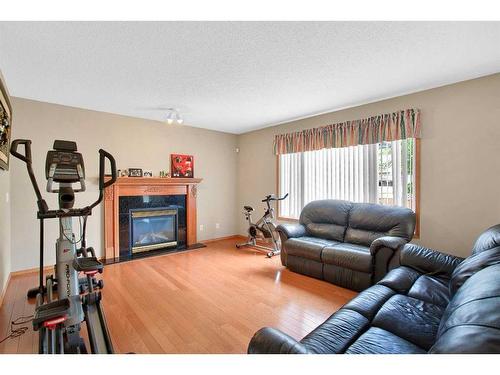 128 West Creek Pond, Chestermere, AB - Indoor Photo Showing Living Room With Fireplace
