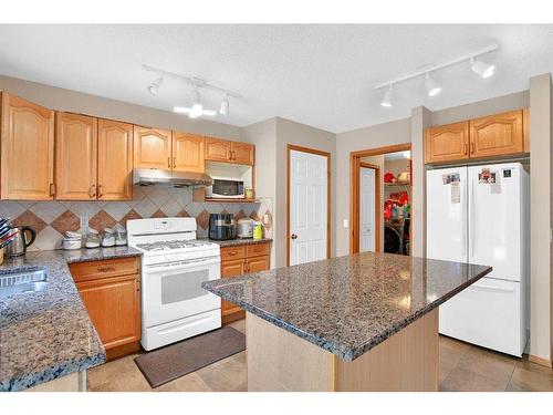 128 West Creek Pond, Chestermere, AB - Indoor Photo Showing Kitchen With Double Sink