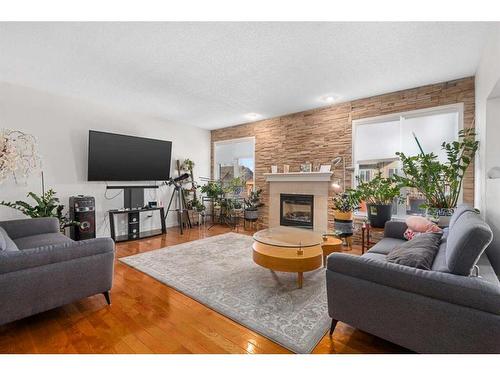 453 Boulder Creek Way Se, Langdon, AB - Indoor Photo Showing Living Room With Fireplace