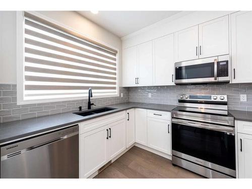 146 Wolf Creek Rise Se, Calgary, AB - Indoor Photo Showing Kitchen With Double Sink
