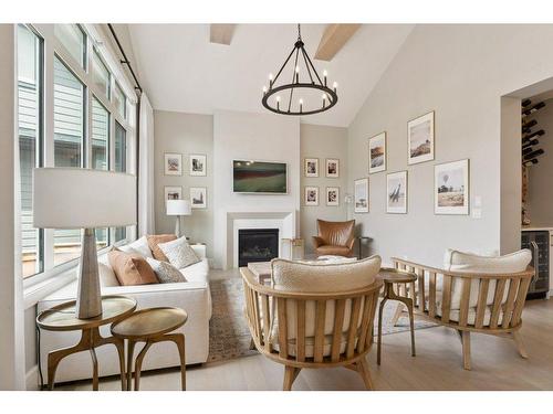 147 Marina Landing Se, Calgary, AB - Indoor Photo Showing Dining Room With Fireplace