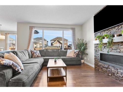 203 Boulder Creek Bay Se, Langdon, AB - Indoor Photo Showing Living Room With Fireplace
