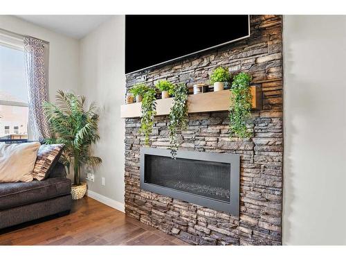203 Boulder Creek Bay Se, Langdon, AB - Indoor Photo Showing Living Room With Fireplace
