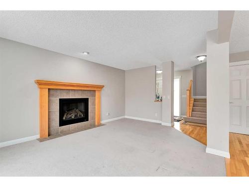 51 Everbrook Link Sw, Calgary, AB - Indoor Photo Showing Living Room With Fireplace
