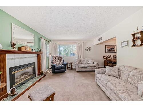 7611 Farrell Road Se, Calgary, AB - Indoor Photo Showing Living Room With Fireplace