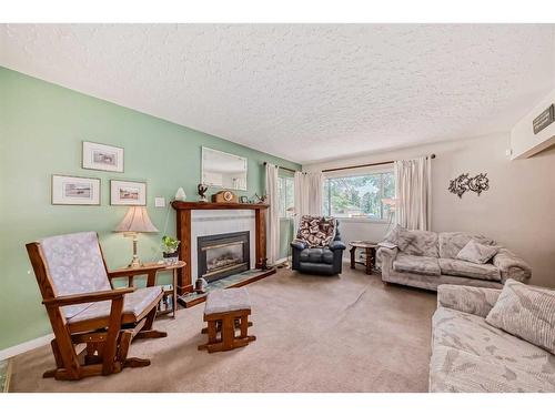 7611 Farrell Road Se, Calgary, AB - Indoor Photo Showing Living Room With Fireplace