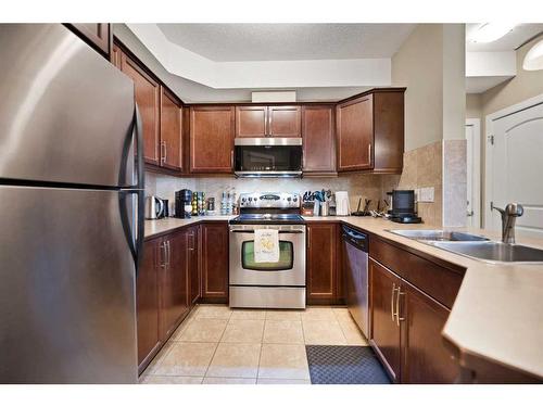 112-15304 Bannister Road Se, Calgary, AB - Indoor Photo Showing Kitchen With Stainless Steel Kitchen With Double Sink