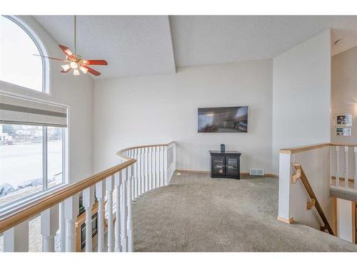 128 Coral Shores Cape Ne, Calgary, AB - Indoor Photo Showing Other Room With Fireplace