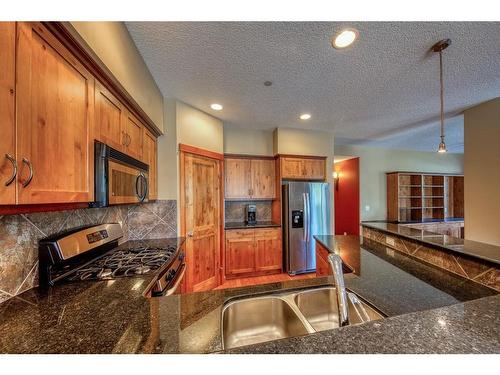 310-107 Armstrong Place, Canmore, AB - Indoor Photo Showing Kitchen With Double Sink