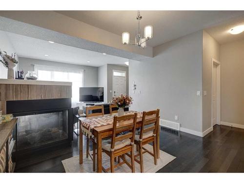 1-405 33 Avenue Ne, Calgary, AB - Indoor Photo Showing Dining Room With Fireplace