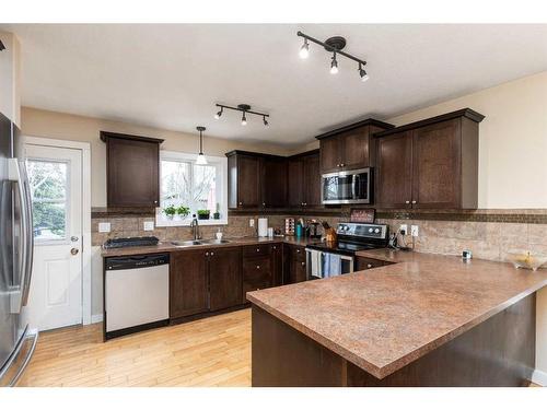 31 Mackenzie Way, Carstairs, AB - Indoor Photo Showing Kitchen With Double Sink
