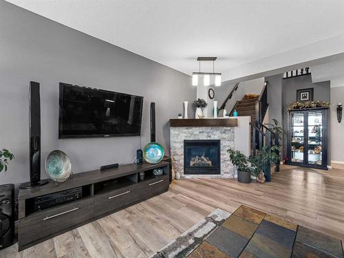 114 Heritage Landing, Cochrane, AB - Indoor Photo Showing Living Room With Fireplace