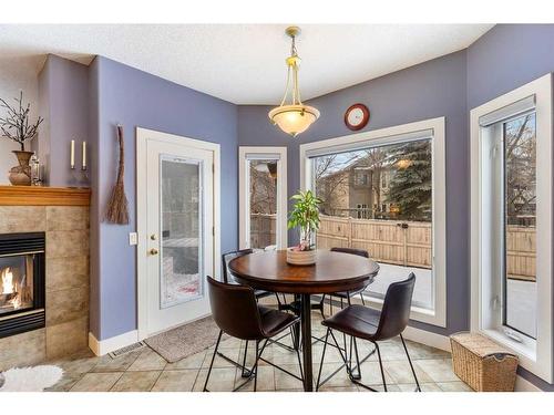 123 Chapala Crescent Se, Calgary, AB - Indoor Photo Showing Dining Room With Fireplace