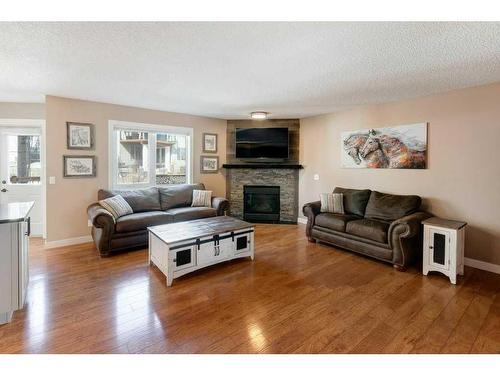 5 Bow Ridge Lane, Cochrane, AB - Indoor Photo Showing Living Room With Fireplace
