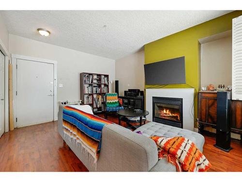 101-3501 15 Street Sw, Calgary, AB - Indoor Photo Showing Living Room With Fireplace