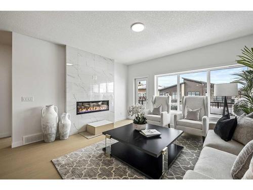 149 Marina Cove Se, Calgary, AB - Indoor Photo Showing Living Room With Fireplace