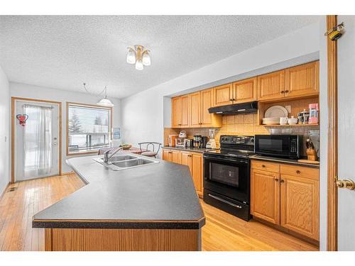 38 Arbour Butte Crescent Nw, Calgary, AB - Indoor Photo Showing Kitchen With Double Sink