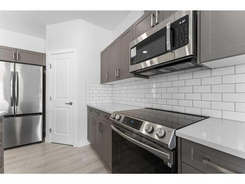 59 Belgian Crescent, Cochrane, AB - Indoor Photo Showing Kitchen With Upgraded Kitchen
