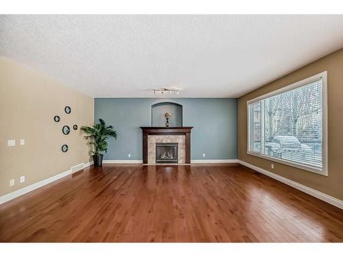 227 Everglade Circle Sw, Calgary, AB - Indoor Photo Showing Living Room With Fireplace