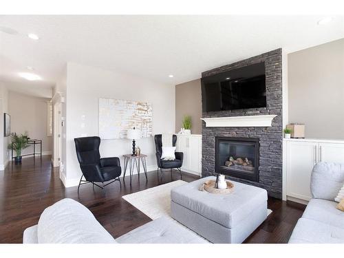 653 Coopers Crescent Sw, Airdrie, AB - Indoor Photo Showing Living Room With Fireplace