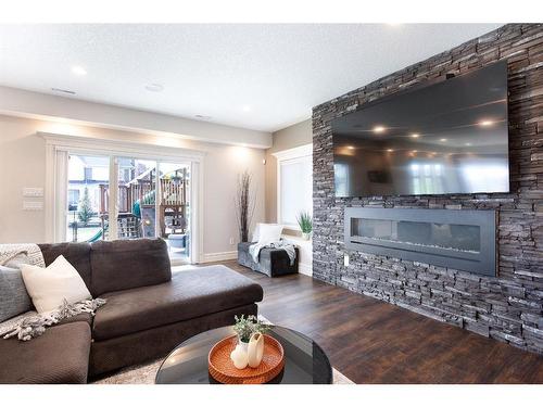 653 Coopers Crescent Sw, Airdrie, AB - Indoor Photo Showing Living Room With Fireplace