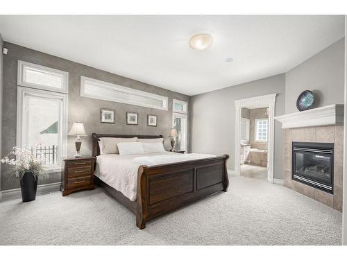 11 Aspen Ridge Lane Sw, Calgary, AB - Indoor Photo Showing Bedroom With Fireplace