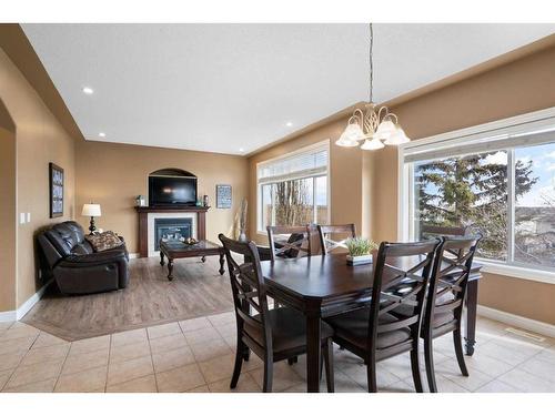143 Arbour Stone Rise Nw, Calgary, AB - Indoor Photo Showing Dining Room With Fireplace