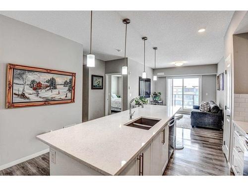 301-4350 Seton Drive Se, Calgary, AB - Indoor Photo Showing Kitchen With Double Sink With Upgraded Kitchen