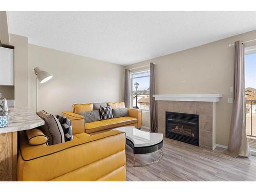 372 Panatella Boulevard Nw, Calgary, AB - Indoor Photo Showing Living Room With Fireplace