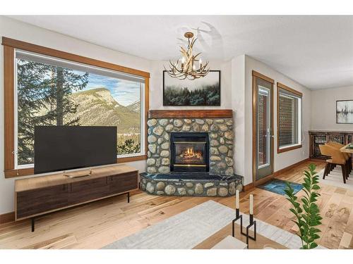 3F-8 Otter Lane, Banff, AB - Indoor Photo Showing Living Room With Fireplace