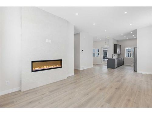 110-595 Mahogany Road Se, Calgary, AB - Indoor Photo Showing Living Room With Fireplace
