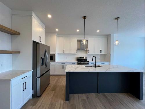35 Heritage Circle, Cochrane, AB - Indoor Photo Showing Kitchen With Upgraded Kitchen