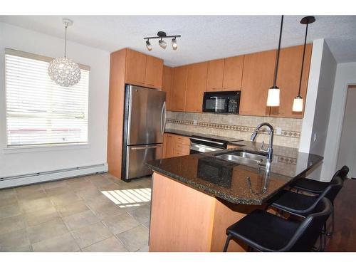 340-22 Richard Place Sw, Calgary, AB - Indoor Photo Showing Kitchen With Double Sink