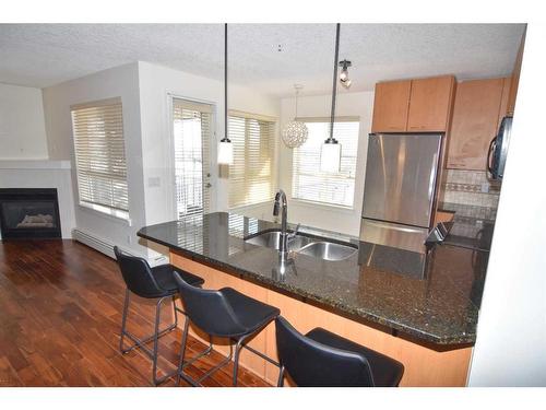 340-22 Richard Place Sw, Calgary, AB - Indoor Photo Showing Kitchen With Fireplace With Double Sink
