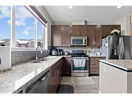 614 Copperpond Boulevard Se, Calgary, AB - Indoor Photo Showing Kitchen With Stainless Steel Kitchen With Double Sink