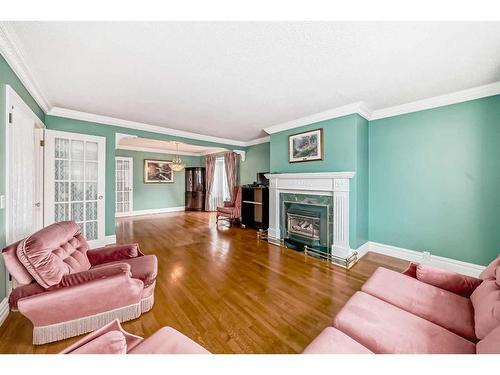 128 Cantree Place Sw, Calgary, AB - Indoor Photo Showing Living Room With Fireplace