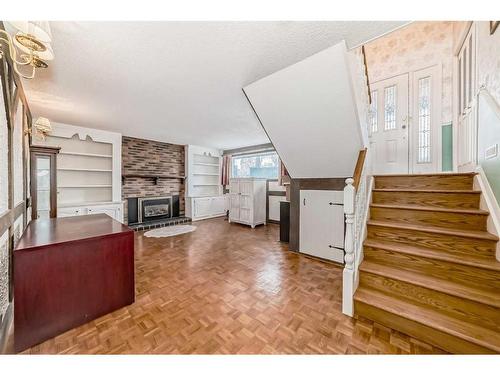 128 Cantree Place Sw, Calgary, AB - Indoor With Fireplace