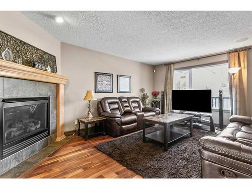 84 Everbrook Drive Sw, Calgary, AB - Indoor Photo Showing Living Room With Fireplace