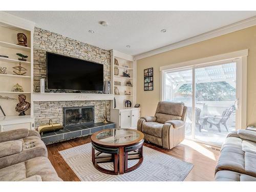 247 Pump Hill Crescent Sw, Calgary, AB - Indoor Photo Showing Living Room With Fireplace