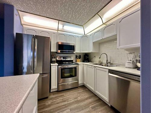 1408-1000 Millrise Point Sw, Calgary, AB - Indoor Photo Showing Kitchen With Double Sink