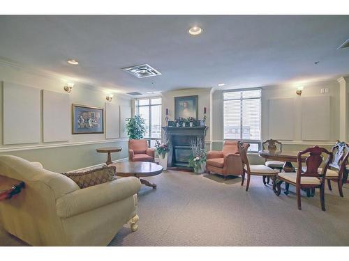 902-1726 14 Avenue Nw, Calgary, AB - Indoor Photo Showing Living Room With Fireplace