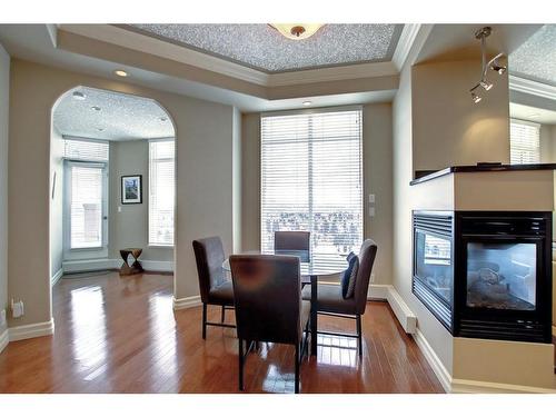 902-1726 14 Avenue Nw, Calgary, AB - Indoor Photo Showing Dining Room With Fireplace