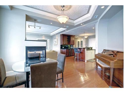 902-1726 14 Avenue Nw, Calgary, AB - Indoor Photo Showing Dining Room With Fireplace