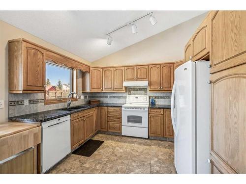83 Riverview Circle, Cochrane, AB - Indoor Photo Showing Kitchen With Double Sink