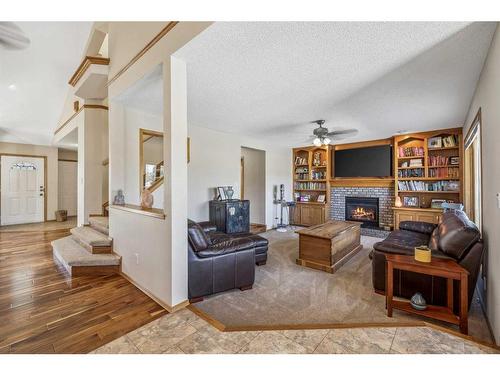 83 Riverview Circle, Cochrane, AB - Indoor Photo Showing Living Room With Fireplace