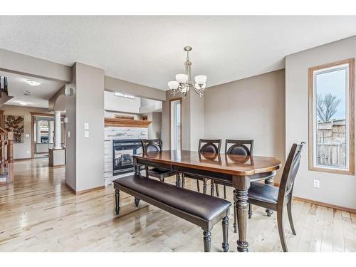159 Evanscove Heights Nw, Calgary, AB - Indoor Photo Showing Dining Room With Fireplace
