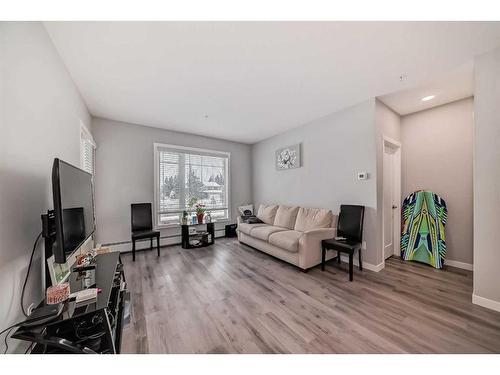 207-200 Shawnee Square Sw, Calgary, AB - Indoor Photo Showing Living Room