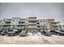 207-200 Shawnee Square Sw, Calgary, AB  - Outdoor With Balcony With Facade 