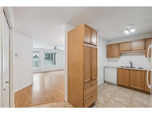 2103-928 Arbour Lake Road Nw, Calgary, AB - Indoor Photo Showing Kitchen With Double Sink